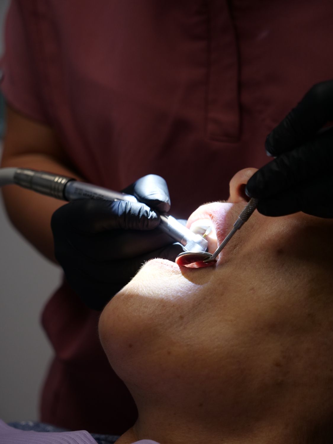 Dental professional providing general dental treatment